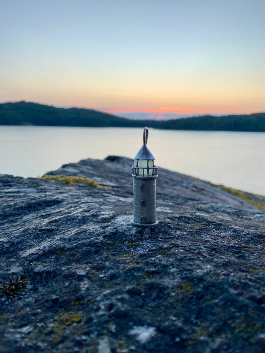 Silver Lighthouse pendant on cliff