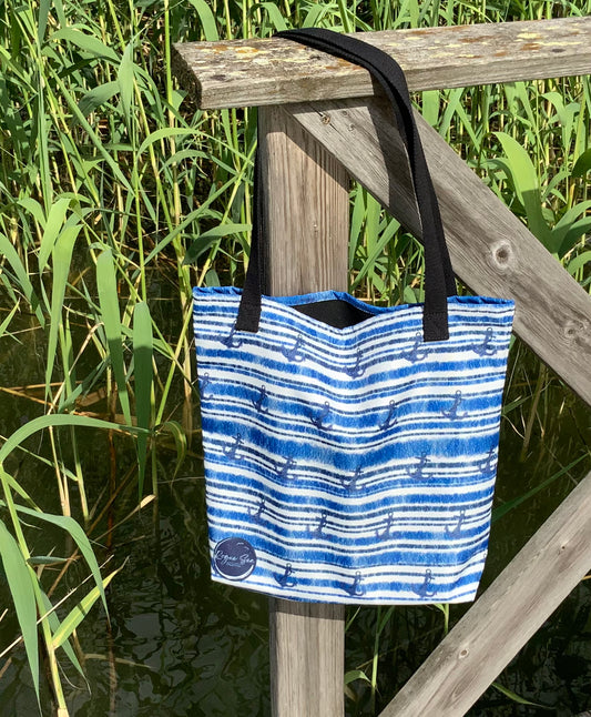 Nautical tote bag hanging on pier reeds background